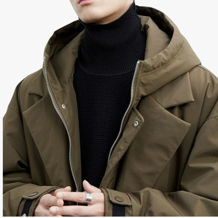 Person wearing a brown jacket with a black turtleneck sweater on a white background